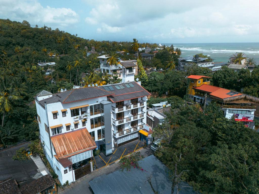 an aerial view of a city with the ocean at Gloria Grand Hotel in Unawatuna