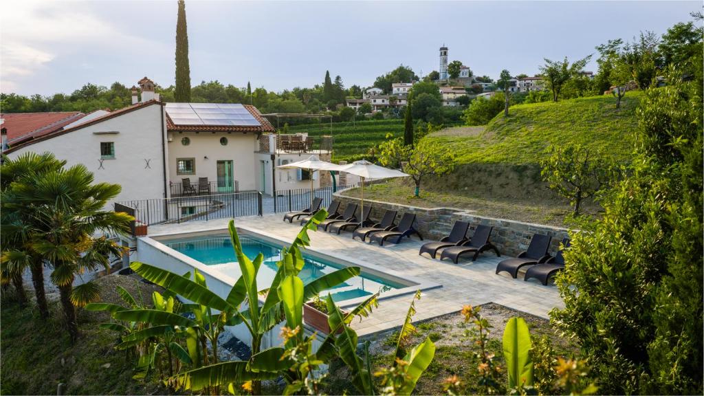 a villa with a swimming pool and a house at Dorče Authentic Country House in Kojsko