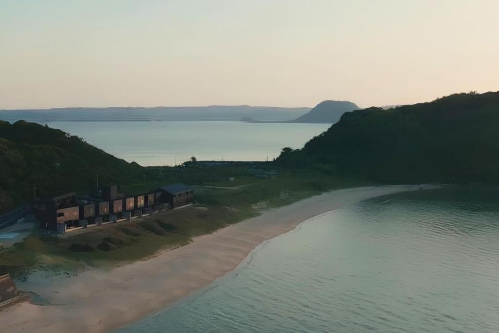 an aerial view of a beach and the ocean at THE SHIKAKA Hotel&Resort BUDOUNOKI in Itoshima