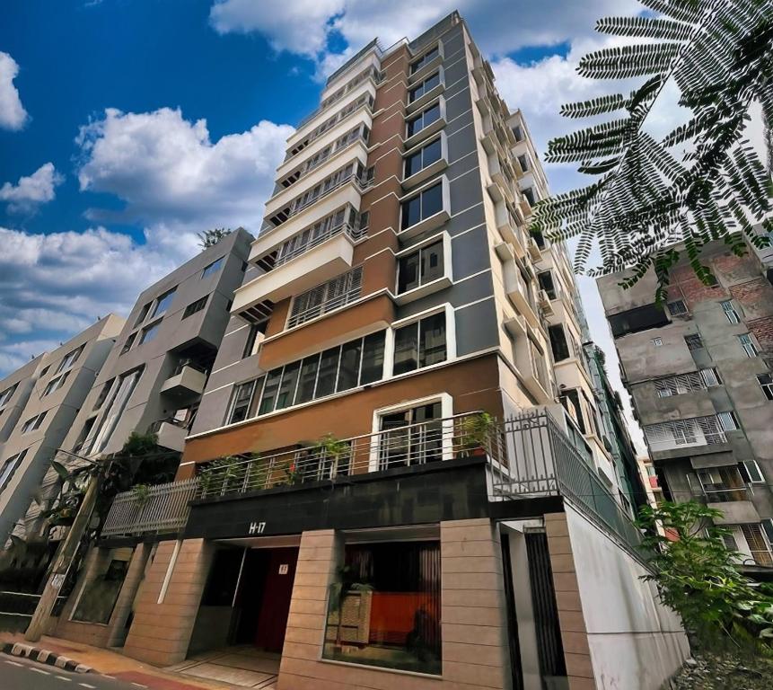 a tall apartment building with a balcony at Nascent Gardenia Residence in Dhaka