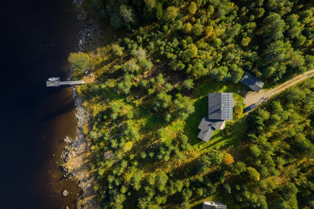 an aerial view of a house in the forest next to a river at Oravi Villa 1 Teeri in Savonlinna