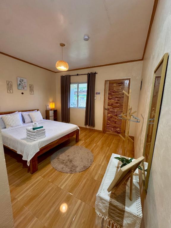 a bedroom with a bed and a wooden floor at R&A Haven Guest House in San Juan