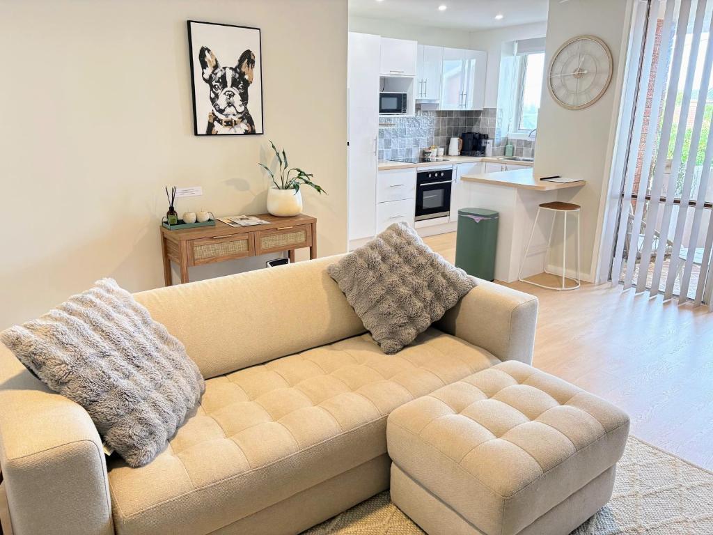a living room with a couch and a kitchen at Melrose Place at Flynn's Beach in Port Macquarie
