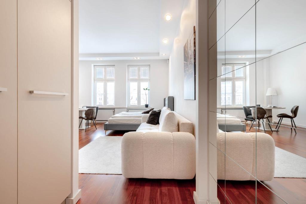 a living room with a couch and a bed at Rynek 45 Apartament in Wrocław