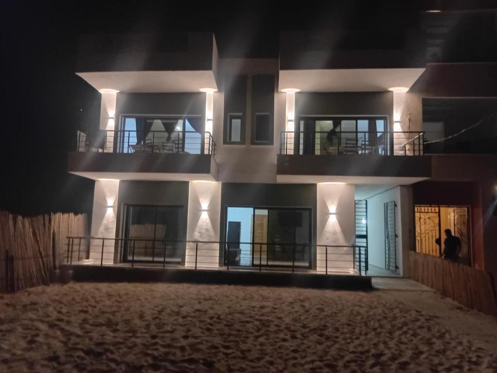 a building with two balconies on it at night at La vague in Île Pilau