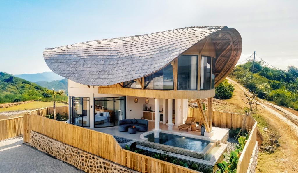 a house with a large roof on top of it at Buenavista Lux Villas in Kuta Lombok
