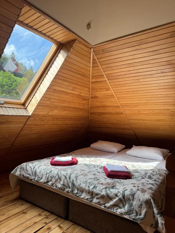 a bed in a room with a large window at Park hotel SVYAT in Skole