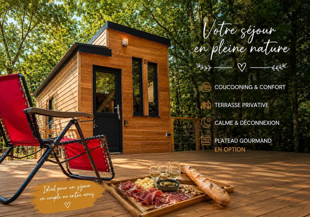 a tiny house on a deck with a tray of food at Tiny house cosy au cœur des bois in Arsac-en-Velay