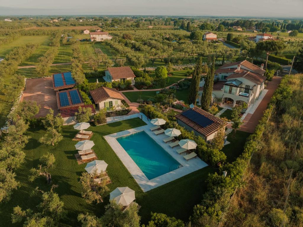 an aerial view of a mansion with a swimming pool and a house at Terre dei Ghelfi Luxury Boutique Apartments & Spa - Adults Only in Castagneto Carducci
