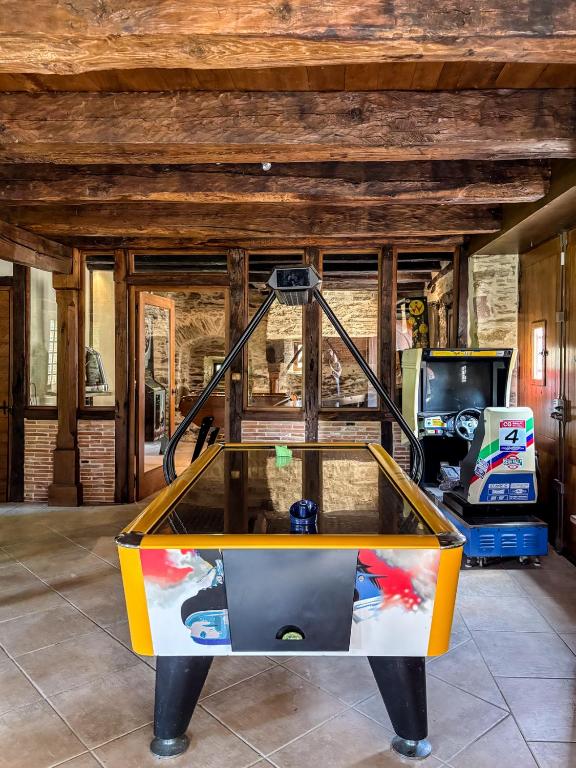 a ping pong table in the middle of a room at Chateau Eyparsac in Beyssac