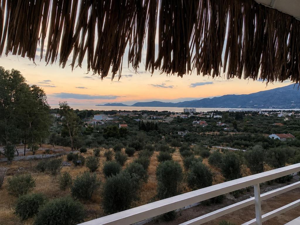 a view from the balcony of a villa with a view of a town at Loutraki Getaway - Cozy and Quiet Nest in Loutraki