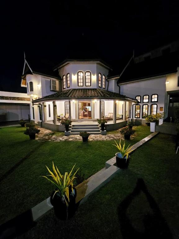 a large white house at night with lights at Airport Luxury Villa 65 - Negombo-Airport Transit Guest in Negombo