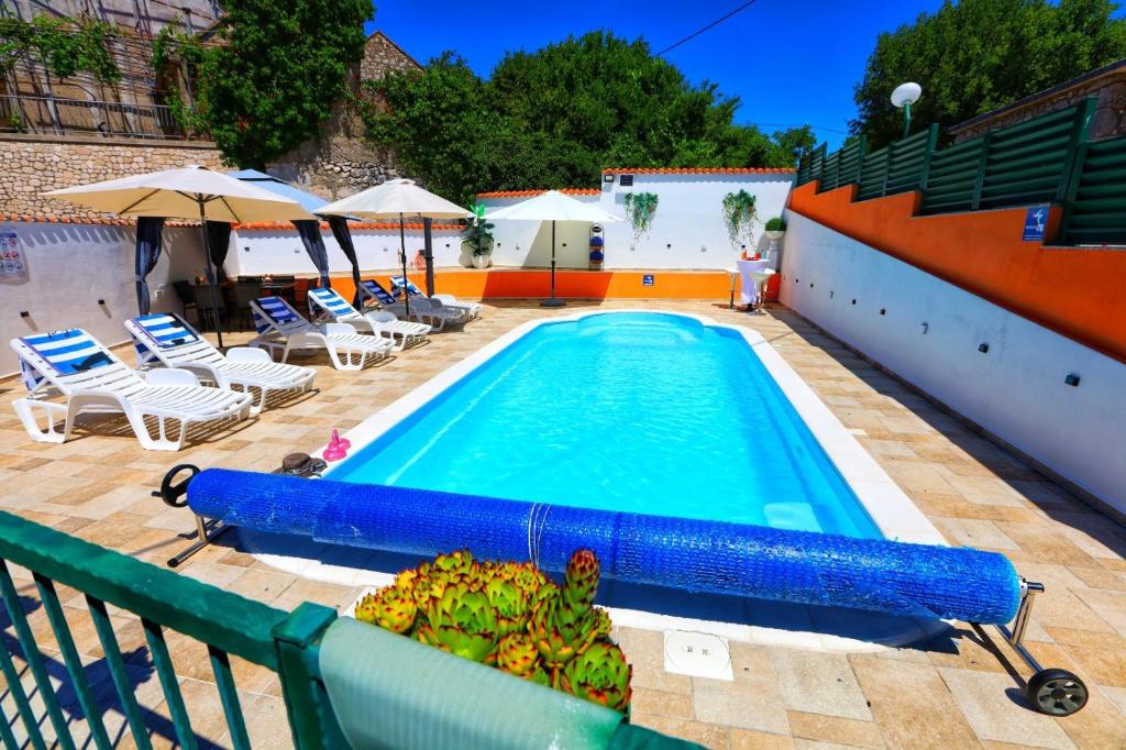 a swimming pool with a bunch of bananas next to it at Holiday Home Rocca with pool in Vrgorac