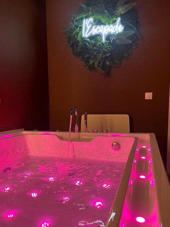 a pink tub with pink lights in a bathroom at Escapade in Saint-Jouin-Bruneval