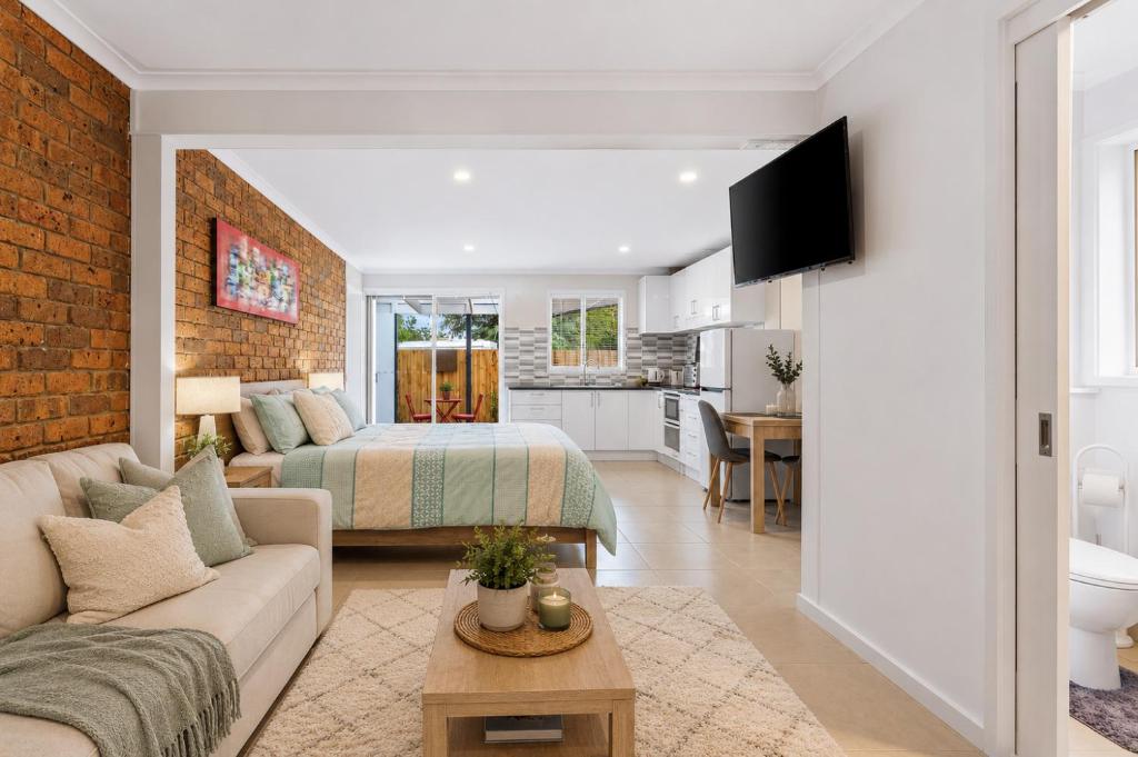 a living room with a couch and a bed at Golfside Getaway 2 by Ready Set Stay in Rosebud