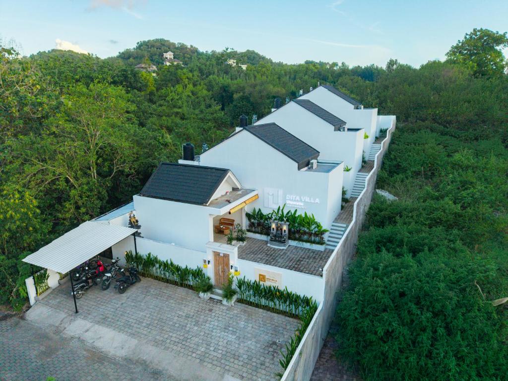 an aerial view of a white house with trees at Dita Villa Uluwatu in Bingin Beach