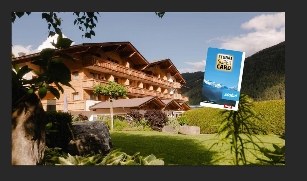 a large building with a sign in front of it at Hotel Brugger in Fulpmes