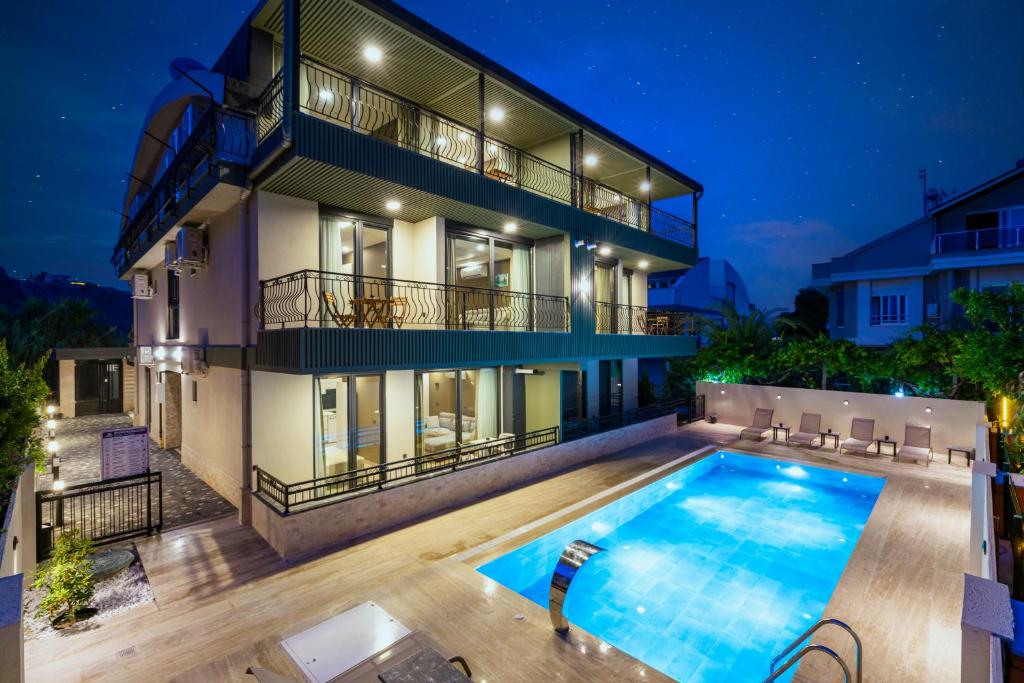 a house with a swimming pool in front of it at Demirel Suites Antalya-Lara Plajlar ve Havalimanına Yakın in Lara
