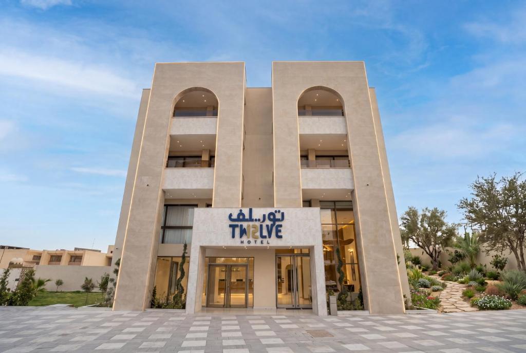 a building with a sign that reads all of the hype at Twelve Hotel in Baghdād