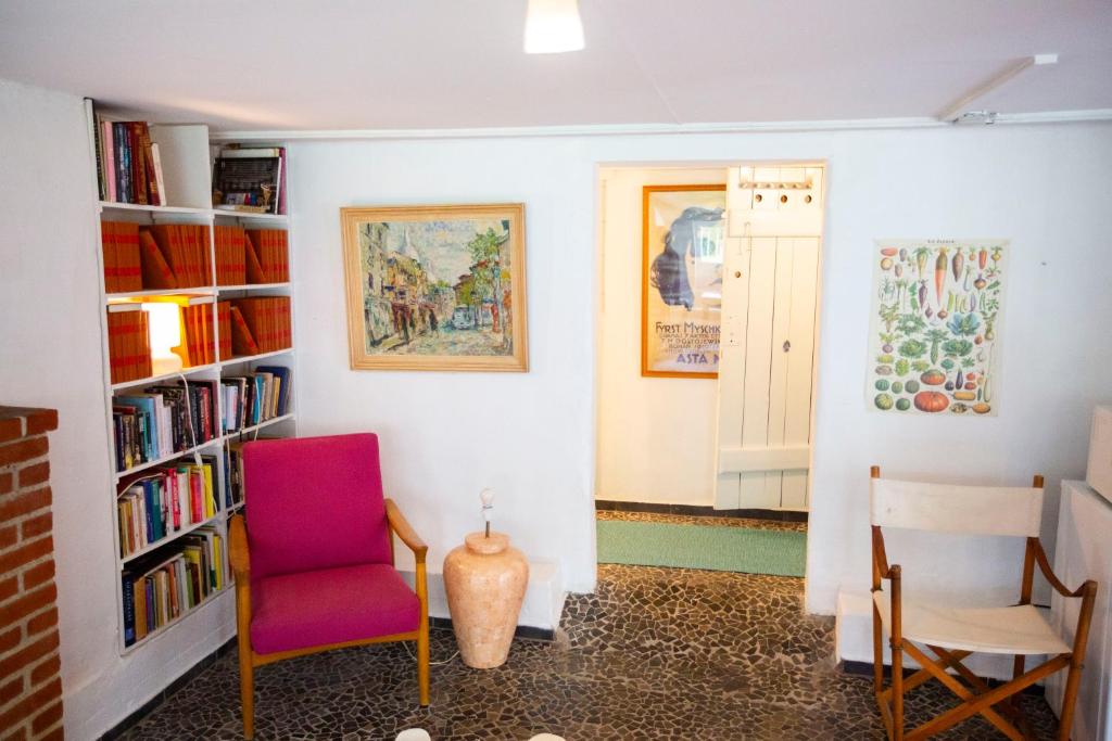 a room with two chairs and a book shelf at Private 2 prs basement I spacious & central CPH in Copenhagen