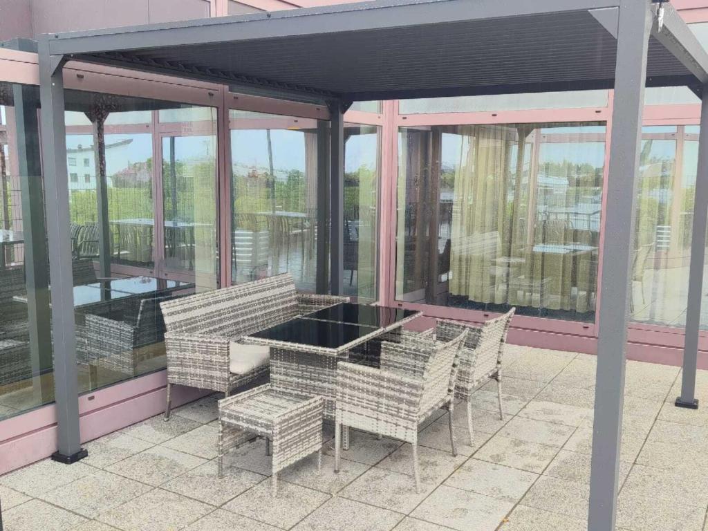 a screened in porch with a table and chairs at Sitya Hostel München in Munich