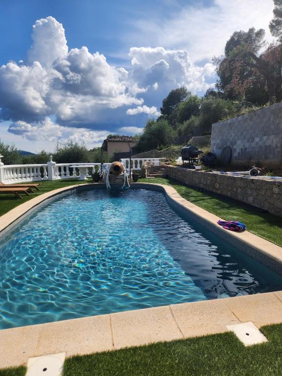 a swimming pool in the yard of a house at Chambre d hote in Le Tignet