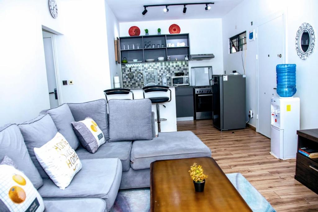 a living room with a couch and a table at Tatu City Serene 2BR Apartment in Tatu City
