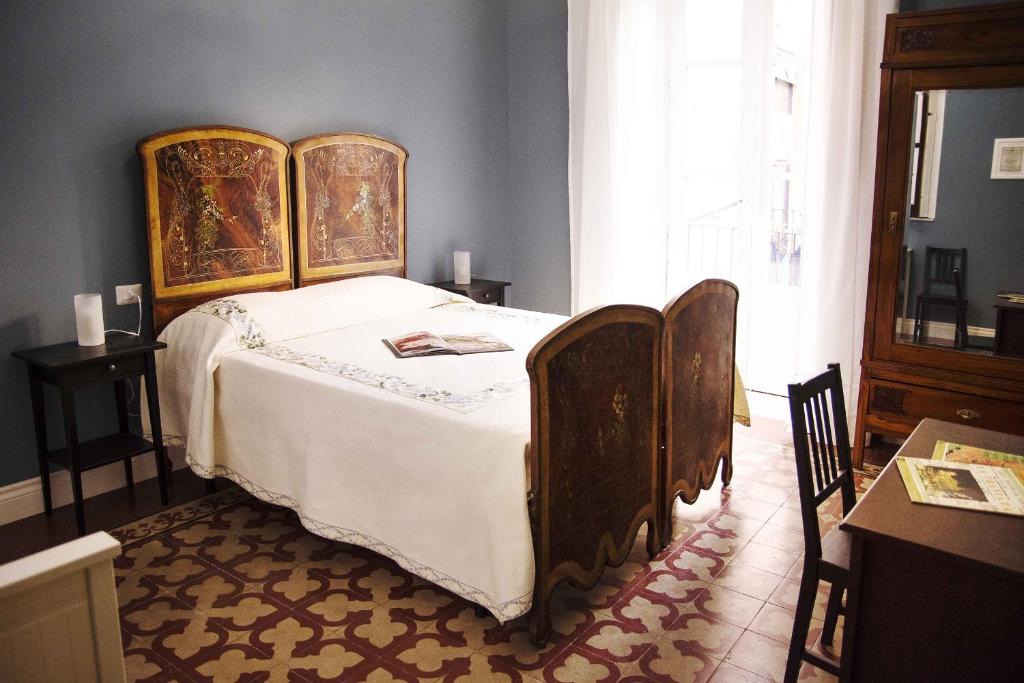 a bedroom with a large bed with a wooden frame at Nabucco Bed & Breakfast in Catania