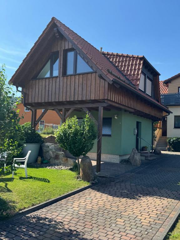 a house with a wooden roof and a brick driveway at Haus Reinsdorf in Blankenburg