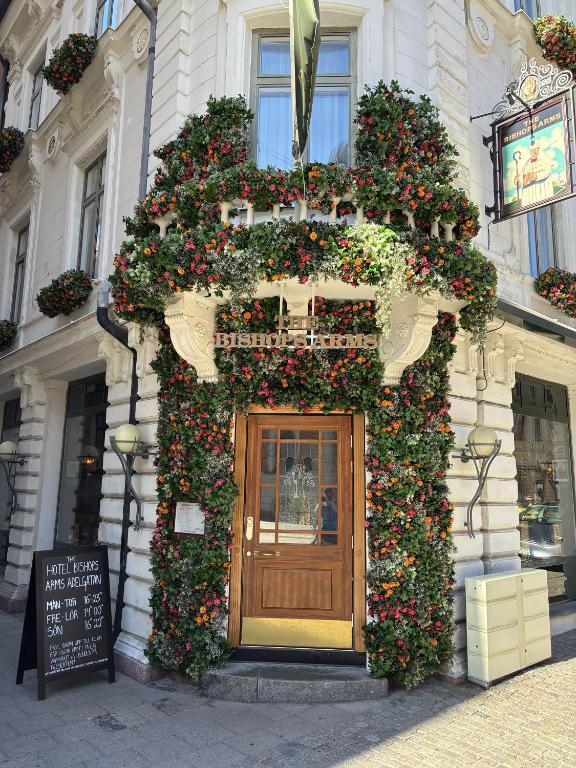 a building with a door covered in flowers at Hotel Bishops Arms Malmö in Malmö
