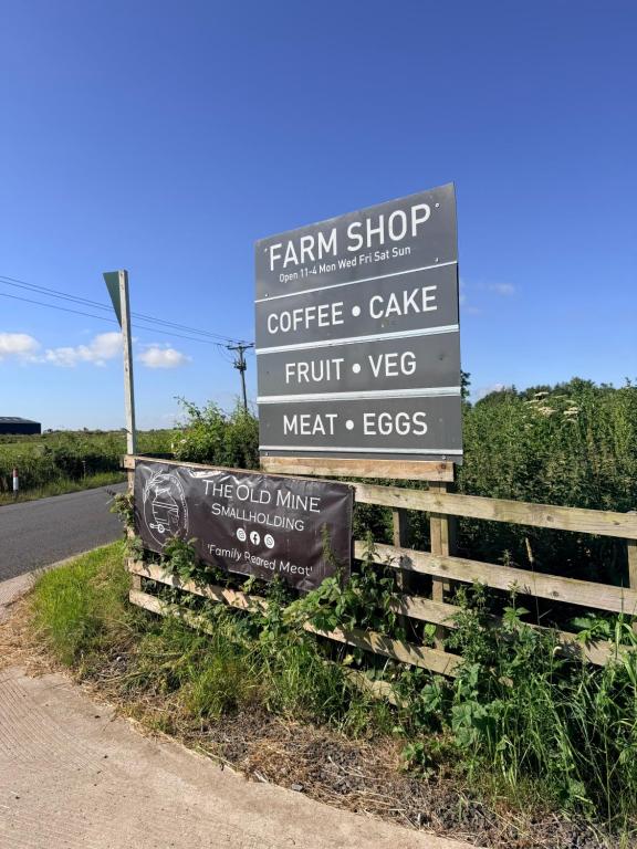 a sign for a farm shop on the side of a road at Vinnies hideaway in Morpeth