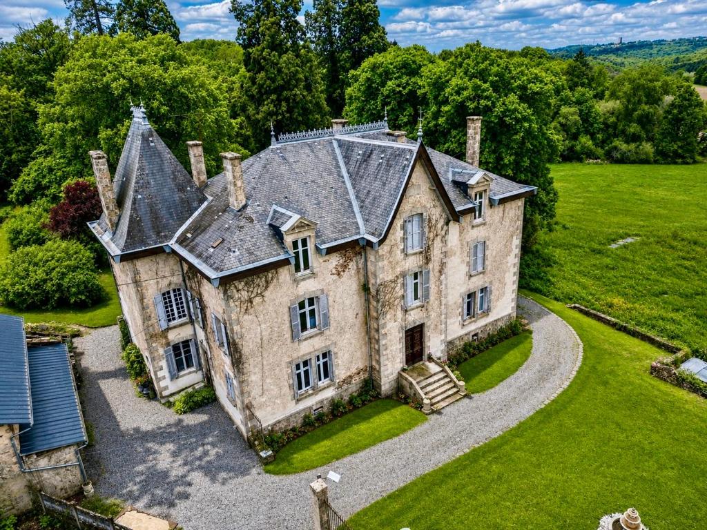 an old stone house with a gray roof at Chateau Mas Levrault in Saint-Priest-Taurion