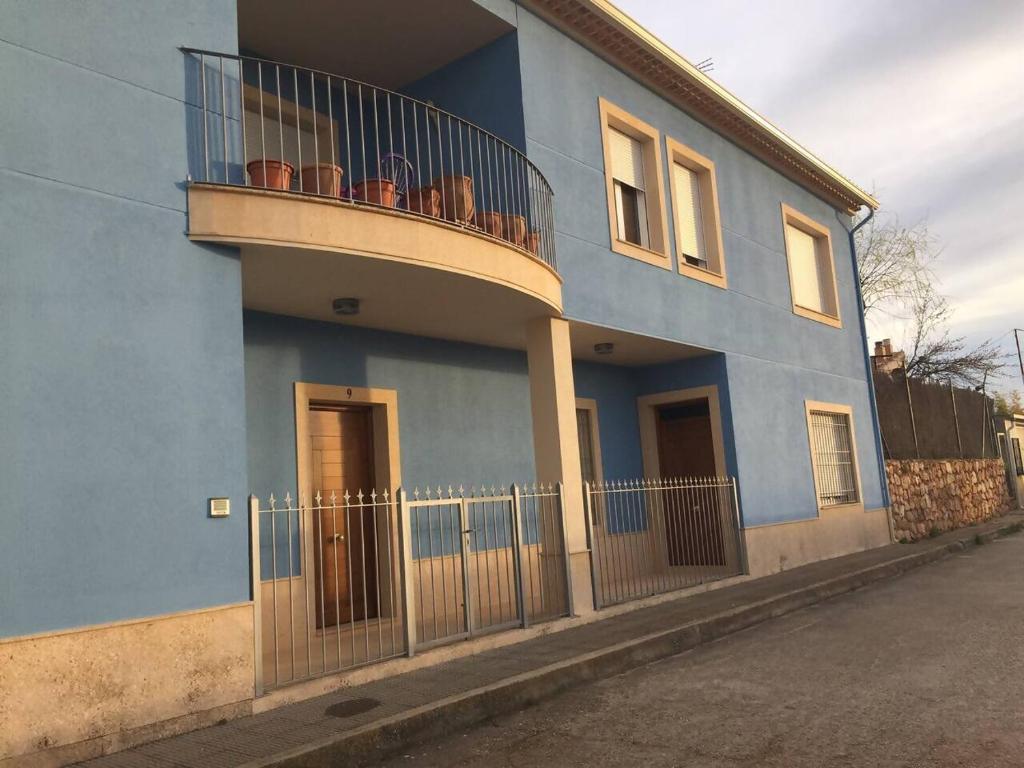 a blue house with a balcony on the side of it at Casa Laureana in Ruidera