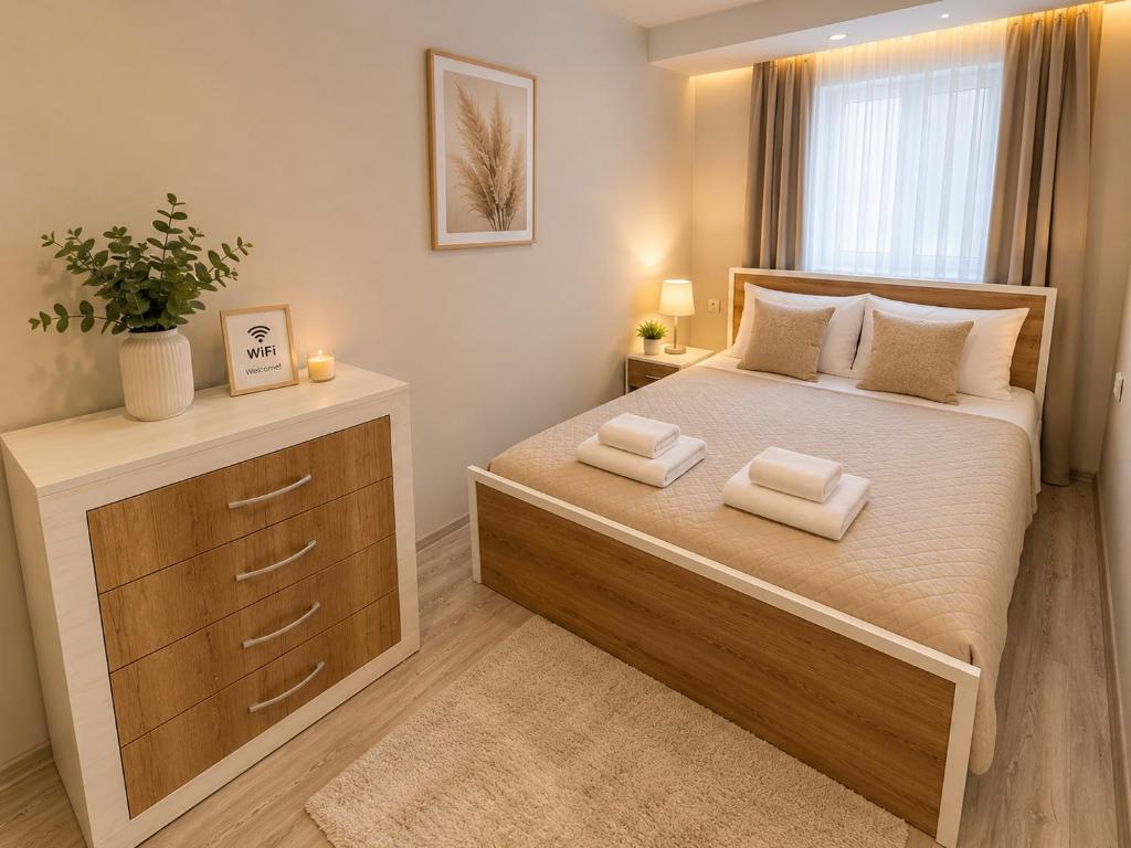 a bedroom with a bed with two towels on it at Catherdral Apartments with Parking in Varna City