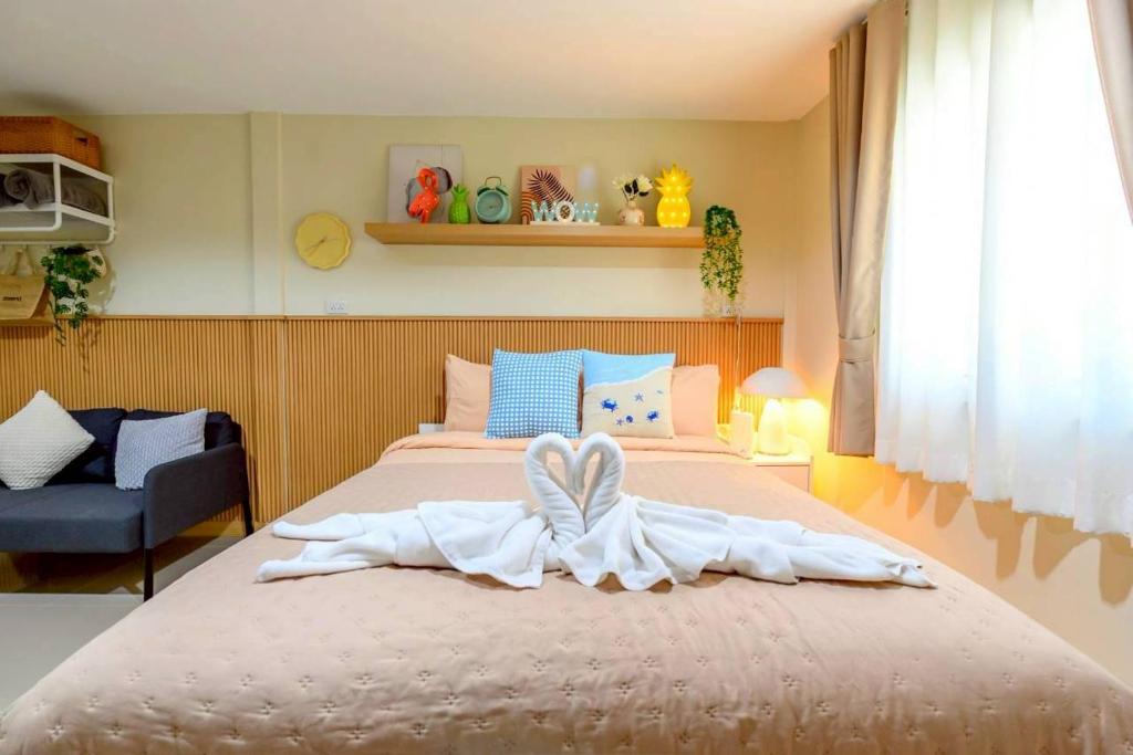 a bedroom with a large bed with a towel on it at Peridot Pool Beach in Chaweng Noi Beach