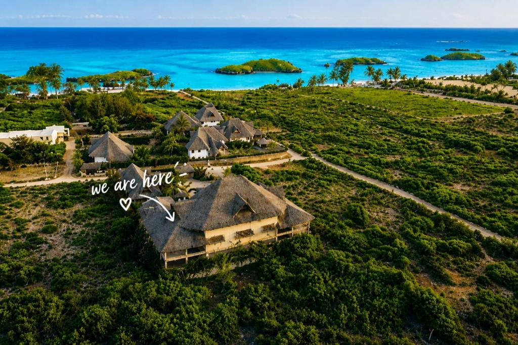 an aerial view of a house on a hill next to the ocean at Ocean zuri villa in Watamu