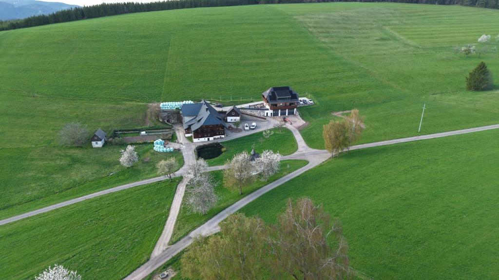 an aerial view of a house in a green field at Ferienhaus am Kapellenhof in Triberg