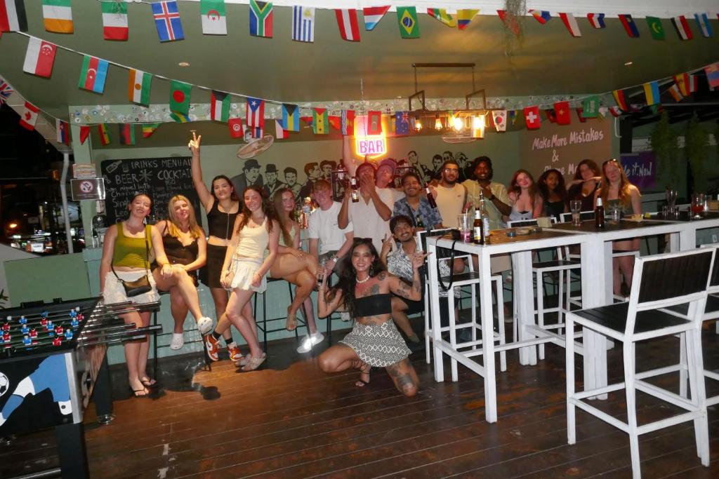 a group of people posing for a picture in a bar at Zostel Phuket, Patong Beach Hostel in Patong Beach