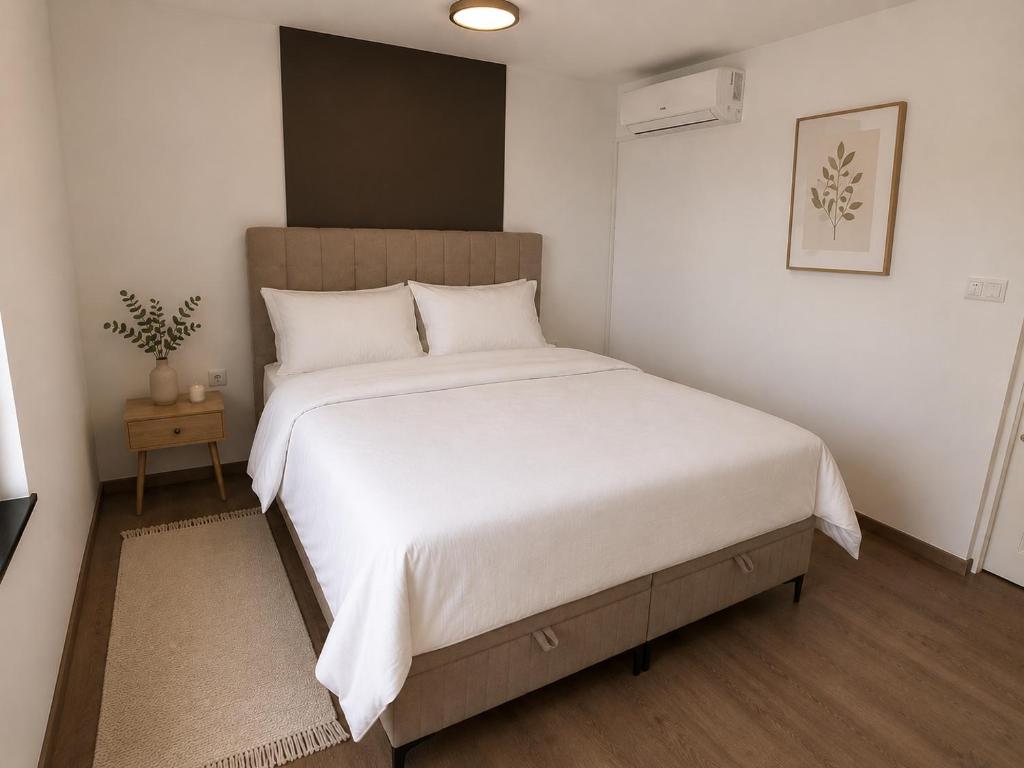 a bedroom with a large bed with white sheets at Ranč Zlatne niti by Acin salaš in Tordinci