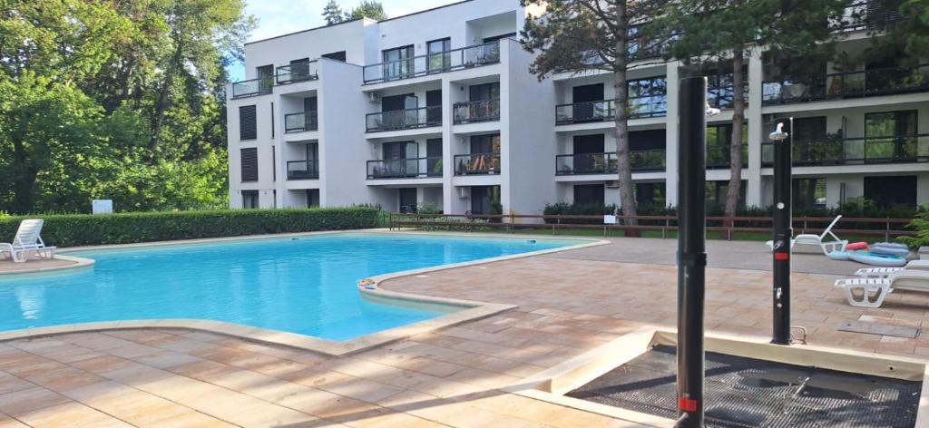 a swimming pool in front of a building at Apartmán GIGI Rezort Linea in Piešťany