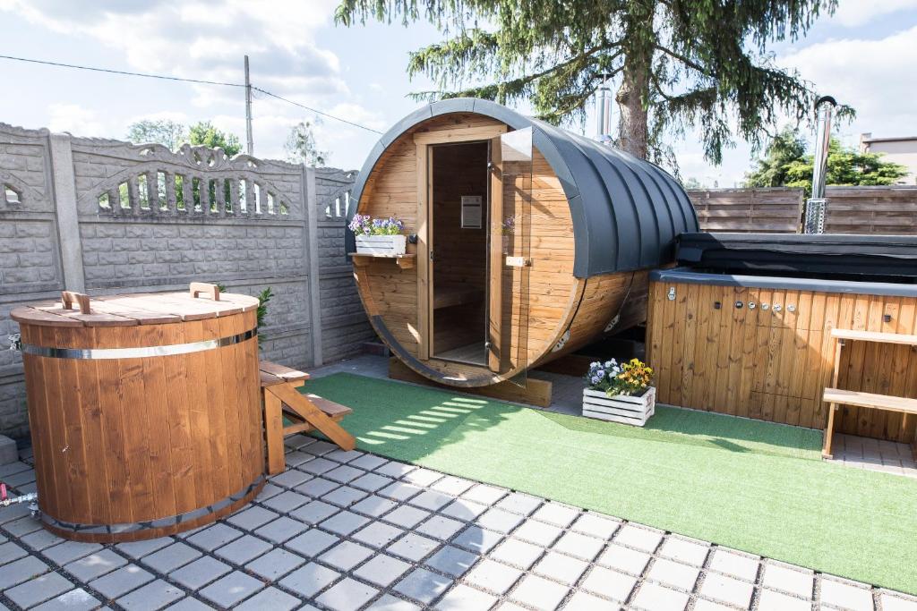 a circular wooden sauna with a wooden table and a bench at Agroturystyka Przy Wodospadzie in Lubrza