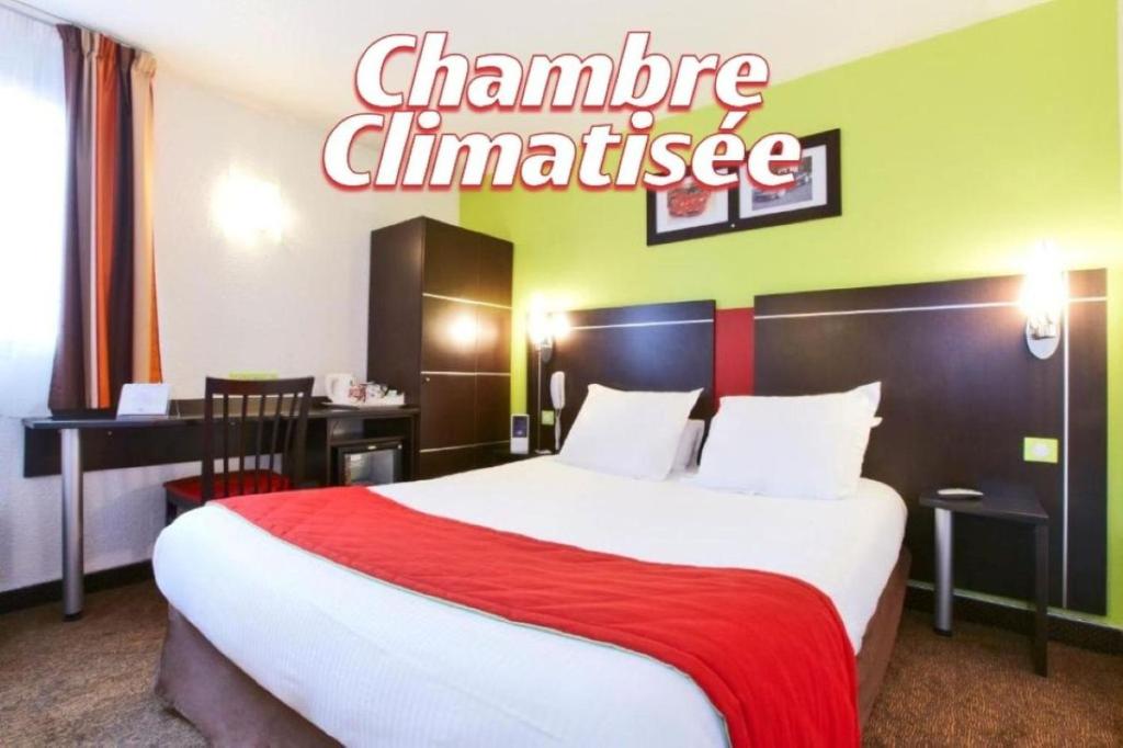 a hotel room with a large bed with a red blanket at Enzo Hotels Reims Tinqueux in Reims