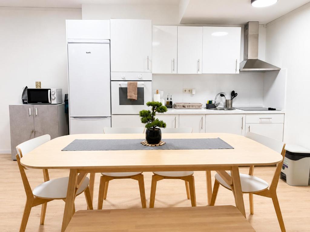 a kitchen with a wooden table with a potted plant on it at Aroma D Valencia Luxury and Designer Apartment in Valencia