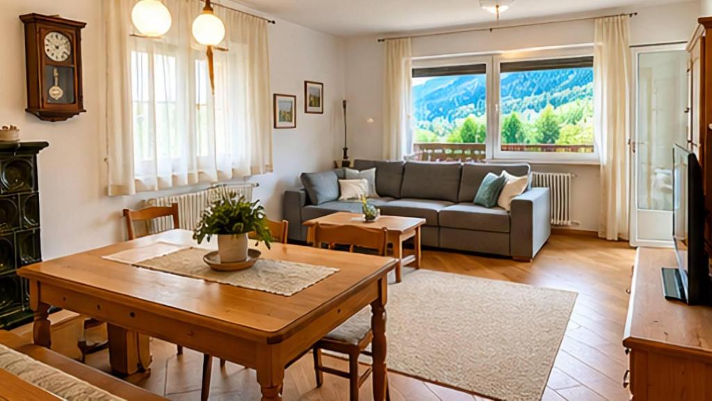 a living room with a couch and a table at Appartamento Graziella in Castello di Fiemme