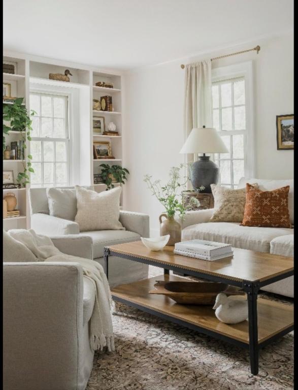 a living room with two couches and a coffee table at 4cs apartment in Bayanan