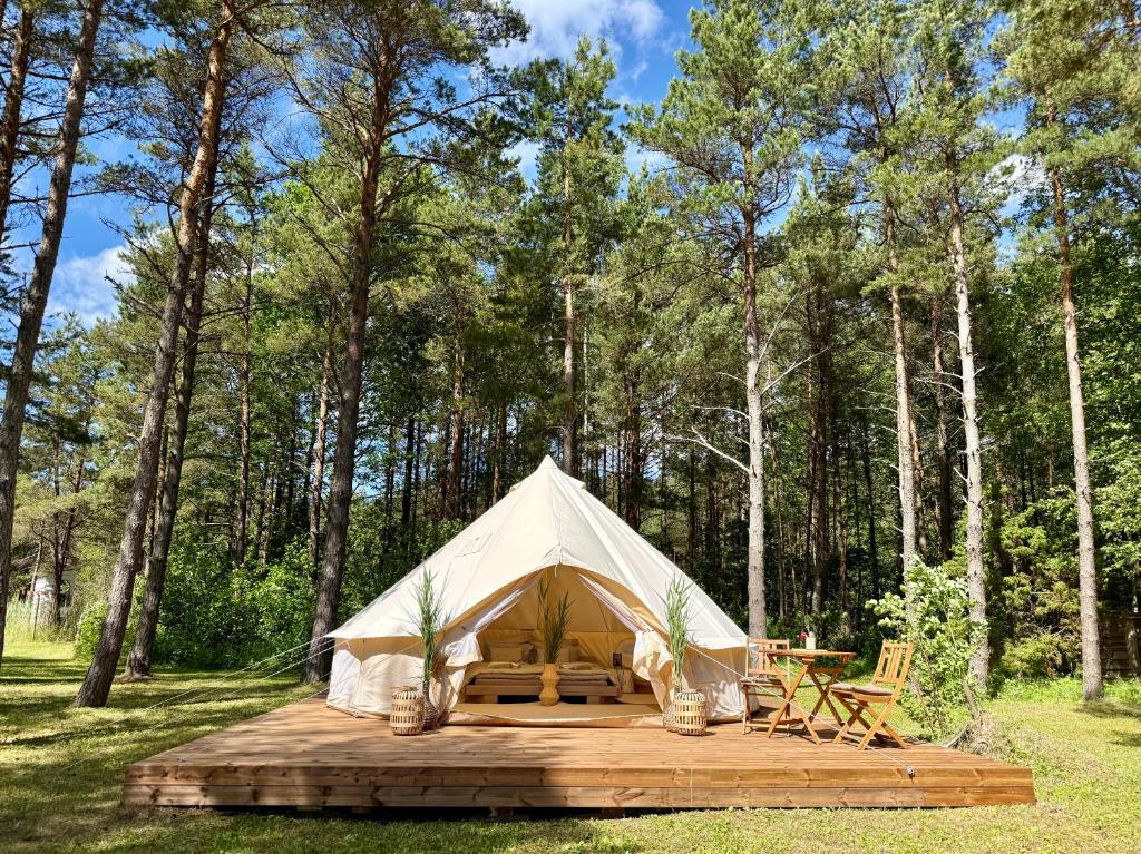 a white tent in the middle of a forest at Mändjala Glamping in Mändjala