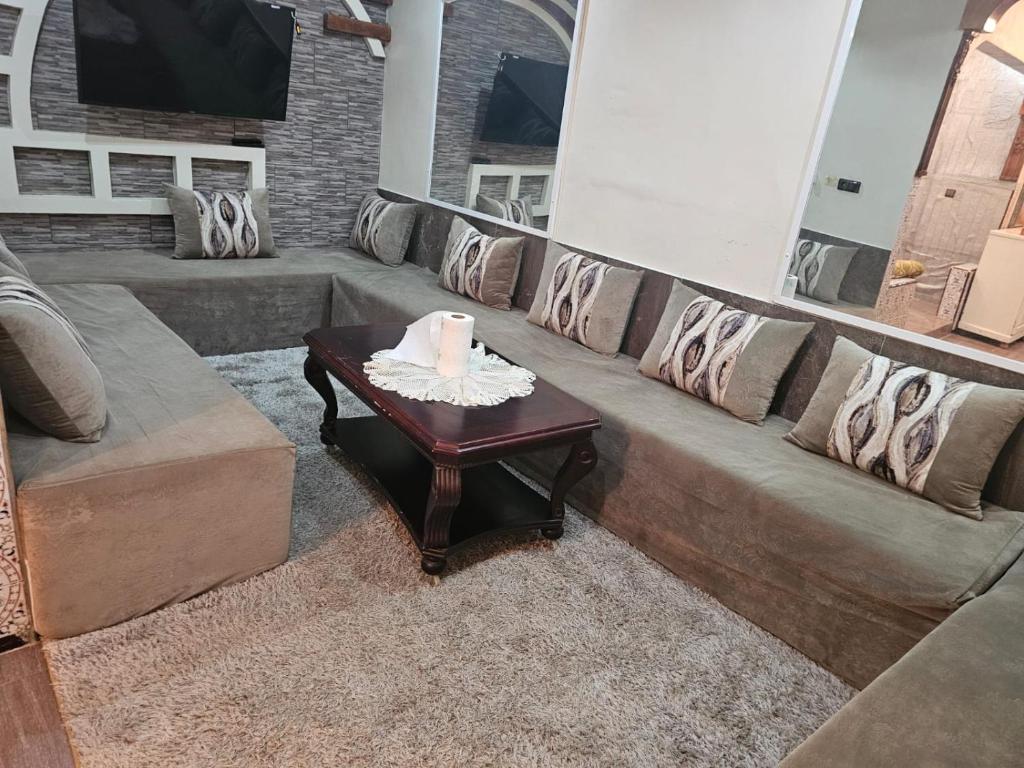 a living room with a couch and a table with a candle at La Casa de Larache in Larache