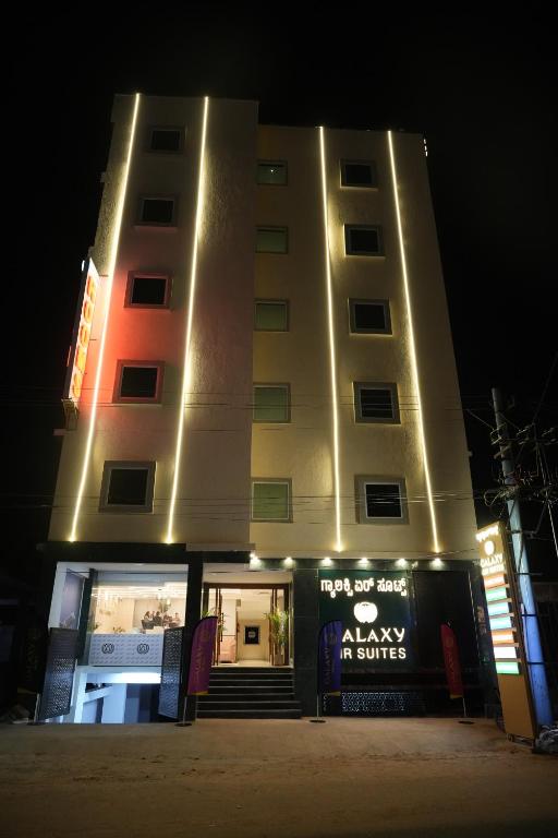 a building with a sign in front of it at night at Galaxy Air Suites in Bangalore