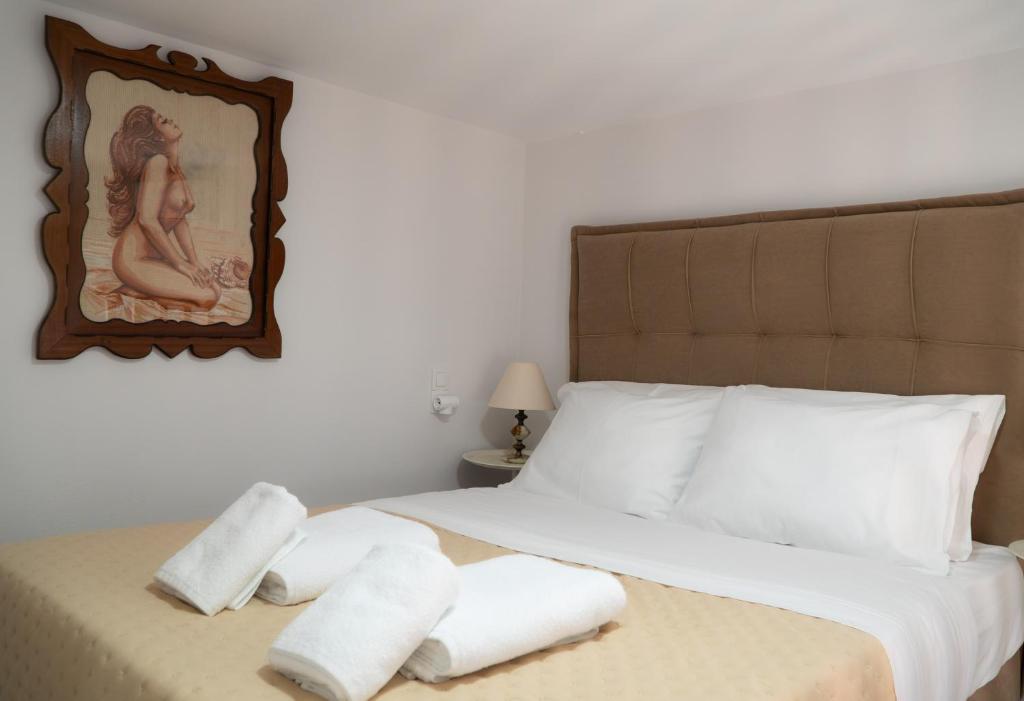 a bedroom with a bed with towels on it at Christie's Home Meteora in Kalabaka