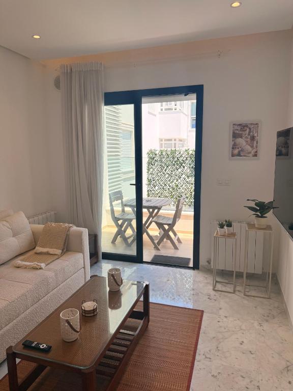 a living room with a couch and a table at Breeze La Marsa in Tunis